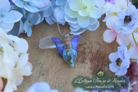 Collier fiole poussiere de fee bleu violet, pendentif aile de papillon, gros plan