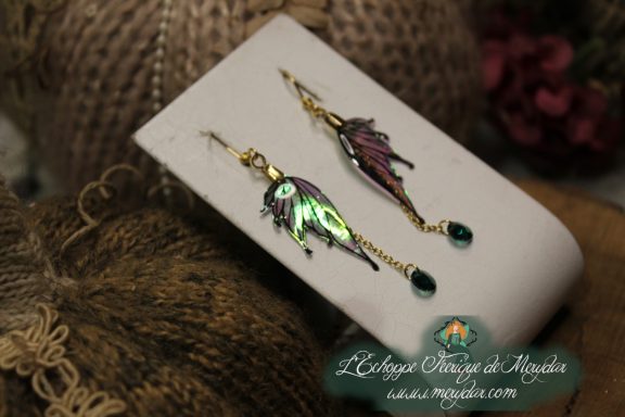 Boucles d'oreilles longues depareillees vertes et bleues avec perle, sur carte