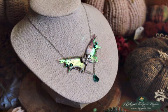 Collier pendentif renard petite aile blanche verte, presente sur buste porte-bijoux