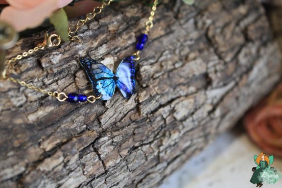 Bracelet chaine avec breloque papillon bleu violet et perles bleu fonce