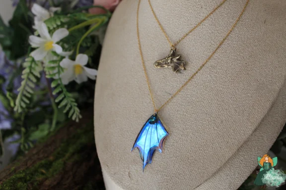 Petit pendentif aile de dragon bleue sur double chaine doree